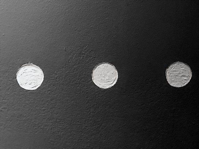 Engraved punctuation marks on the gallery wall