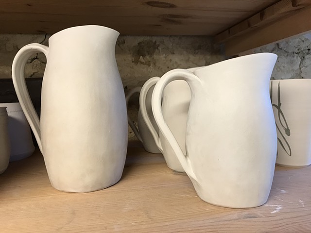 Greenware clay drying on shelves, pitchers, by Carol Naughton Ceramics