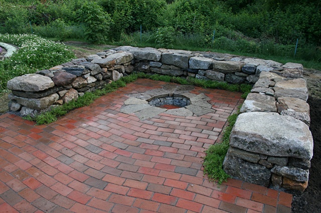 wavy lay brick patio with inset fire pit and sitting walls