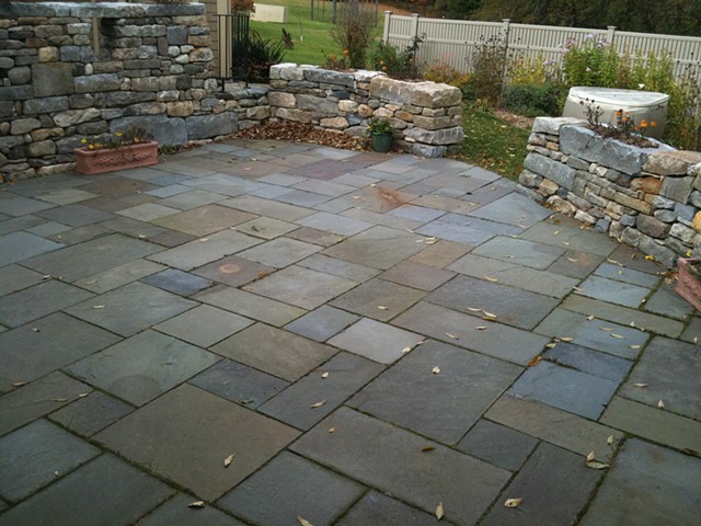 fieldstone walls with custom granite planters and bluestone patio