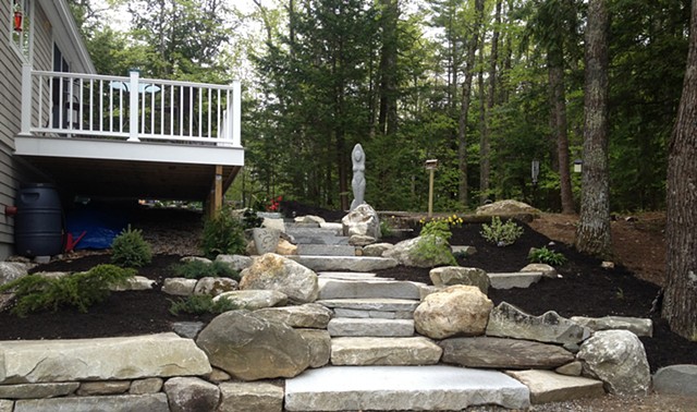 Granite steps and walkways with granite and boulder retaining walls.