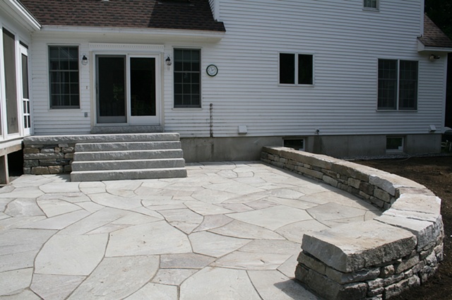 blue stone patio with sitting wall and steps with 12'x4'cantaleavered top landing