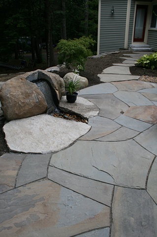 irregular bluestone patio with boulder fountain and bluestone walkway, granite steps