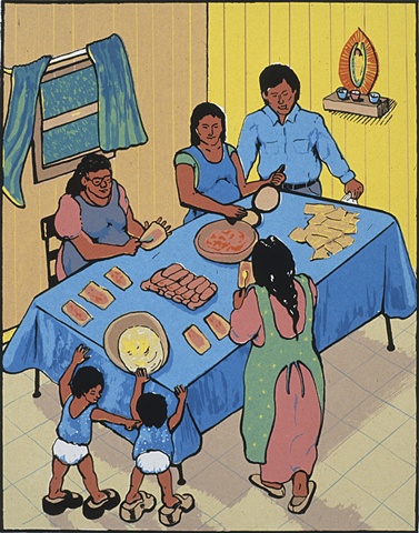 family at a table making tamales