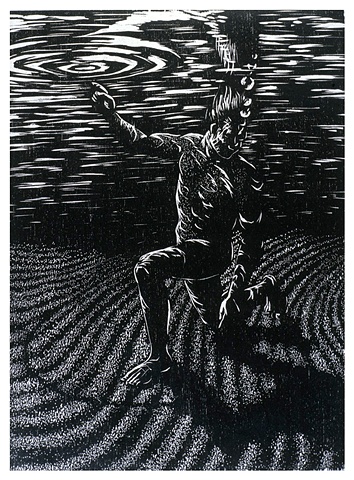 man under water draws on sand with left hand and points to water surface with right hand