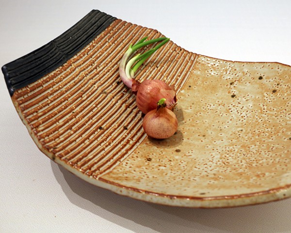 Textured stoneware bowl with applied decoration and glazed with shino and iron oxide