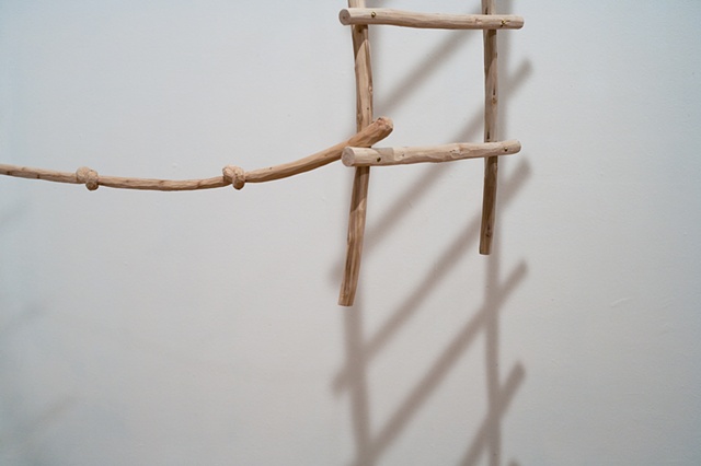 Wood sculpture of ladder and carved knotted rope by Lin Lisberger