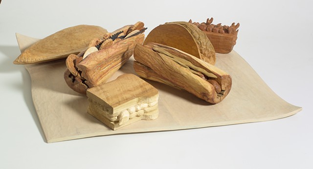 Carved wood sandwiches on a wood cloth by Lin Lisberger