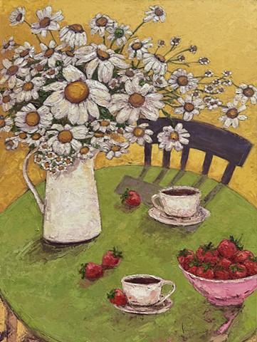A still life of daisies, coffee cups, and strawberries on a chartreuse round table. 