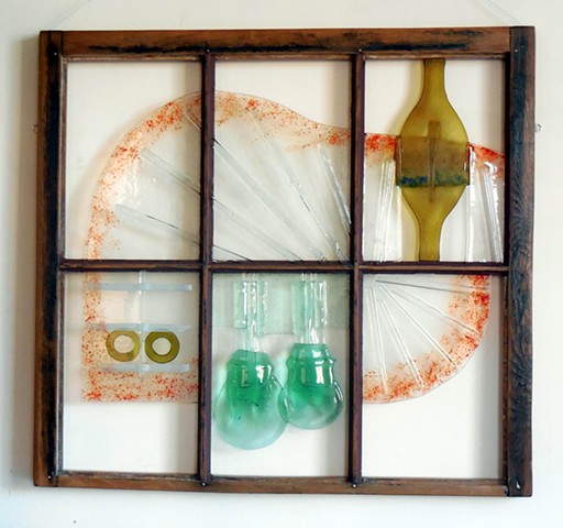 bottle and plate glass, red frit, in old window.