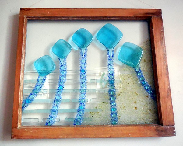 Bottle glass, aquarium buttons, blue and yellow unfired swarf, plate glass in an old window.