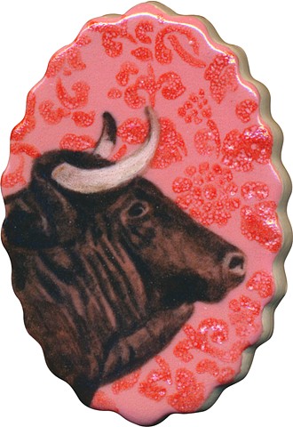 Oval ceramic handmade tile, hand painted with underglazes, bull portrait of Taurus zodiac sign with pink floral background pattern by Chantelle Norton.
