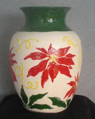 Ivory vase with red poinsettias and dark green trim