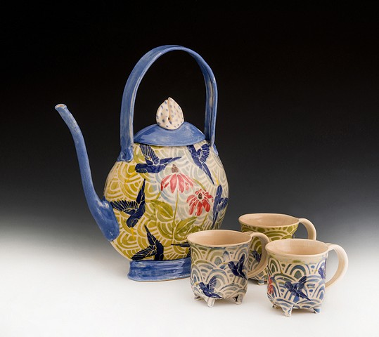 vivid blue collaged hummingbird teapot  with four footed cups