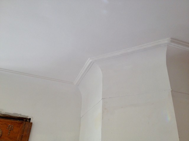 Closer view of swan neck cove moulding with re-created ceiling detail to match existing