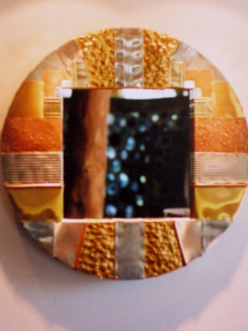 round mirror created from recycled metals with hammered textural areas copper, aluminum cans, etc