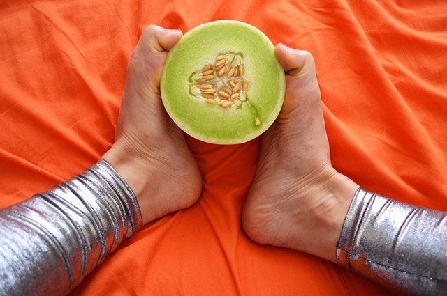 photograph of woman feet legs honeydew melon food silver leggings fetish by Robyn LeRoy-Evans