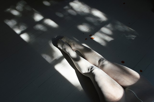 photograph of woman white stockings floorboards dappled sunlight by Robyn LeRoy-Evans