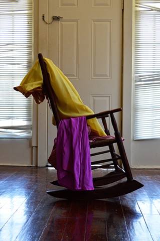photograph of rocking chair door blinds woman clothing by Robyn LeRoy-Evans