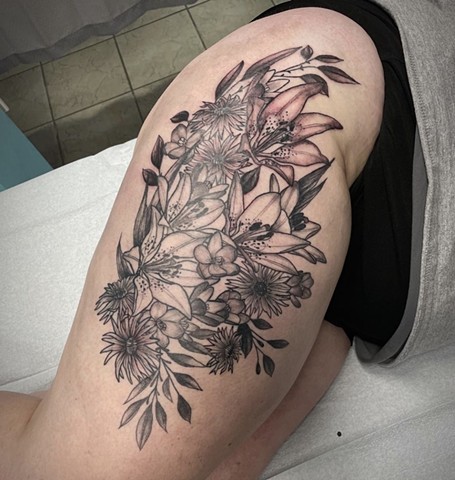 black and grey flower tattoo on upper thigh at Strange World Tattoo Calgary, Alberta Canada