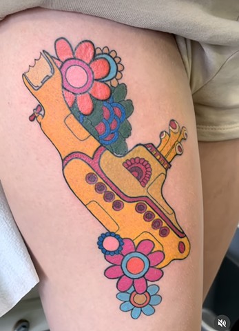 The beatles yellow submarine tattoo on upper thigh Strange World Tattoo Calgary, Alberta Canada