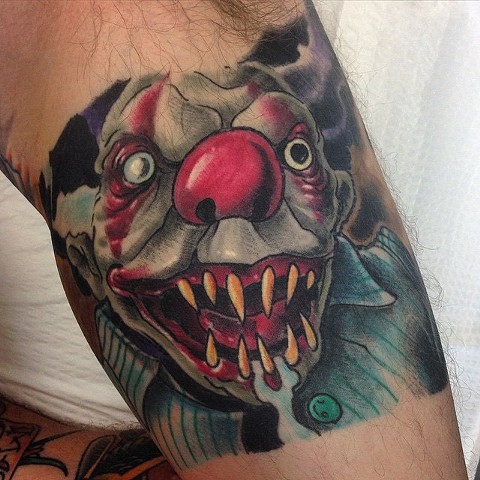Creepy, evil clown tattoo by Brett Schwindt of Strange World Tattoo 