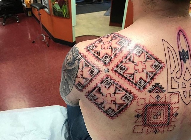 cross-stitch tattoo on shoulder blade Strange World Tattoo Calgary Alberta Canada