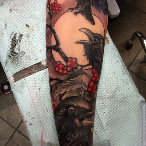 full arm sleeve of black crows, branches and red berries by tattoo artist Brett Schwindt of Strange World Tattoo in Calgary 