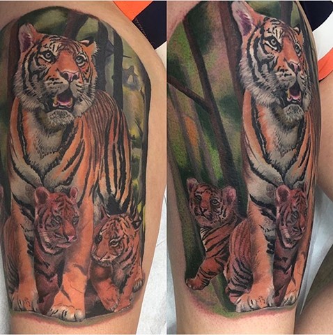 Tiger tattoo in colour on upper thigh Strange World Tattoo Calgary Canada