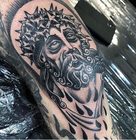 Jesus tattoo on a knee cap in black and grey Strange world tattoo Calgary Alberta Canada 