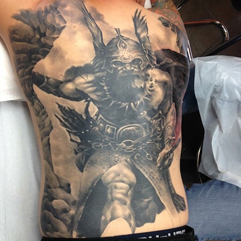 Black and grey viking backpiece tattoo 