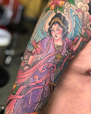 Japanese half sleeve tattoo in colour on upper arm Strange World Tattoo Calgary Alberta Canada 