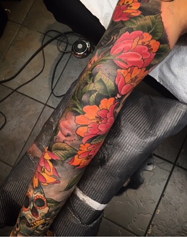 full colour tattoo sleeve of flowers and sugar skulls by tattoo artist Brett Schwindt in Calgary, Canada