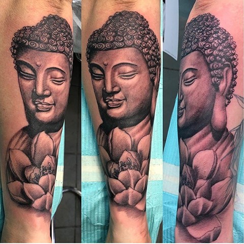 Buddha and Lotus flower tattoo in black and grey Strange World Tattoo Calgary 