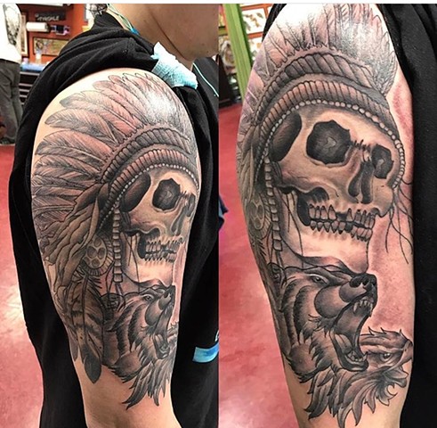 Skull with headdress half sleeve tattoo in black and grey Strange World Tattoo Calgary Alberta Canada 