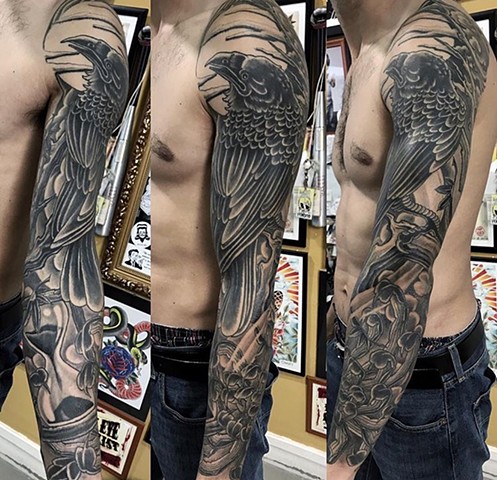 Raven tattoo sleeve in black and grey strange World Tattoo Calgary Alberta Canada 