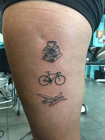 books, bike and plane tattoo 