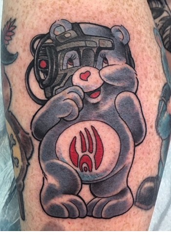 Tattoo artist Brett Schwindt of Strange World Tattoo in Calgary Care Bear tattoo