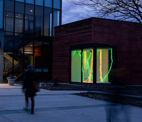 person walking past light installation