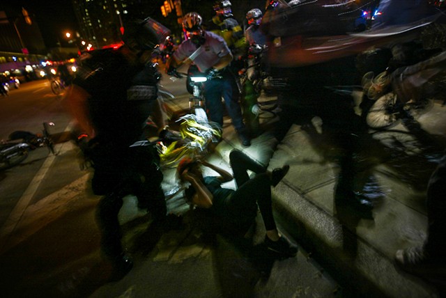 Police detain a protestor during night time demonstrations while the global G20 Summit was held in Pittsburgh, Pa. in Sept. 2009.