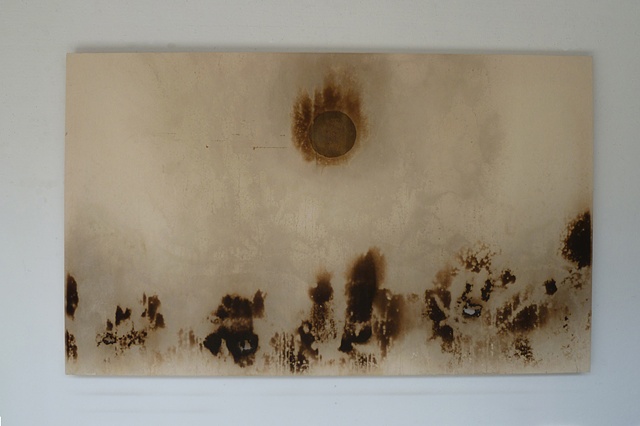 Golden circle of honey and pigment in center of large canvas, smoke markings allong bottom, some scorches.