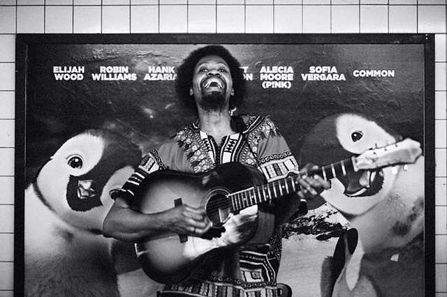 Photograph of a Guitarist with Penguins, 14th Street Subway Station, Manhattan, NY, by Judith Ebenstein