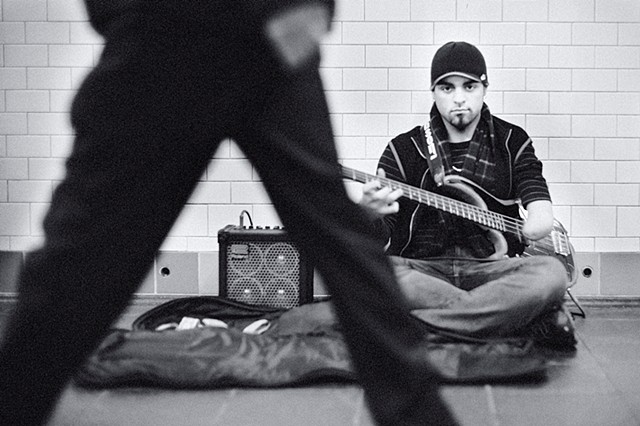 Photograph of a one-armed guitarist, Times Square Subway, Manhattan, NY, by Judith Ebenstein