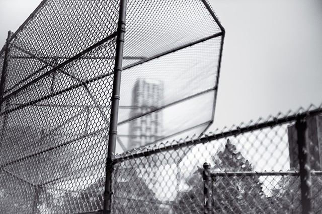 Photograph of a baseball fence with 1214 Fifth Avenue in the background, Central Park, Manhattan, by Judith Ebenstein