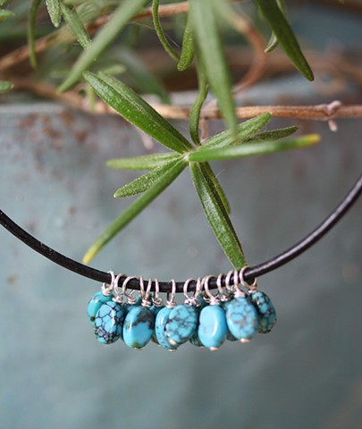 turquoise charm necklace on black leather cord