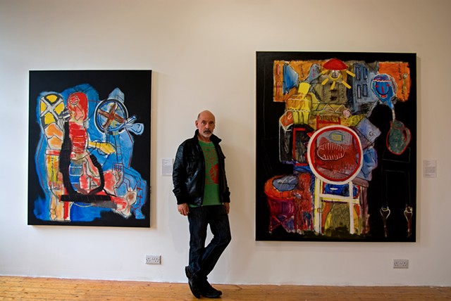 The Artist Gerry Gleason with some of his paintings.
