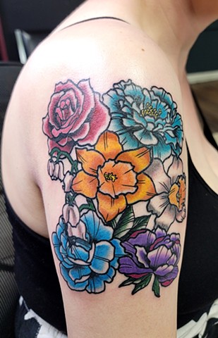 Colorful birth month flower arrangement on upper arm in a traditional tattoo style by Gina Matsuo of Copper Fox Tattoo in Kissimmee Florida Best tattoo shop near me
