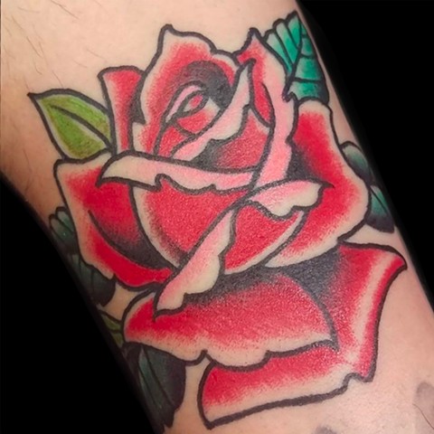 Color traditional tattoo of Rose on lower arm by Gina Marie of Copper Fox Tattoo Company in Kissimmee Florida