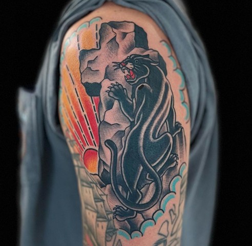 traditional tattoo in full color of crawling panther on stone cross by Klint Who at Copper Fox Tattoo in Kissimmee Florida best traditional shop