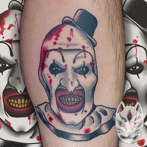 Traditional style Art the Clown tattoo from the slasher film Terrifier on lower leg in full color by Gina Matuo of copper Fox Tattoo in Kissimmee Florida best tattoo shop